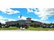 Exterior of community clubhouse with well-maintained grounds, parking, and an American flag at 4734 Cleome Dr, Plainfield, IN 46168