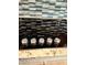 Close up of glass cooktop with granite countertops and mosaic tile backsplash at 4734 Cleome Dr, Plainfield, IN 46168