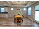 Bright dining area featuring an oak table with seating for six and a stylish modern chandelier at 4734 Cleome Dr, Plainfield, IN 46168