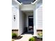Inviting entryway featuring neutral colors, brick accents, and a covered porch at 4734 Cleome Dr, Plainfield, IN 46168