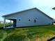 Exterior view showcasing the well-maintained yard and covered patio area at 4734 Cleome Dr, Plainfield, IN 46168