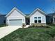 Inviting single-story home with a gray garage door, manicured lawn, and attractive landscaping at 4734 Cleome Dr, Plainfield, IN 46168