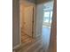 Hallway view into bathroom and bedroom, showcasing the modern flooring throughout the home at 4734 Cleome Dr, Plainfield, IN 46168