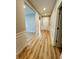 Hallway with decorative trim and hardwood flooring at 4734 Cleome Dr, Plainfield, IN 46168