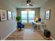 Bright home office with a ceiling fan, white desk, and stylish blue armchair at 4734 Cleome Dr, Plainfield, IN 46168