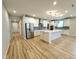 Spacious kitchen featuring stainless steel appliances, a center island, and wood flooring at 4734 Cleome Dr, Plainfield, IN 46168