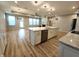 Open concept kitchen and living room featuring granite countertops, stainless appliances, and hardwood flooring at 4734 Cleome Dr, Plainfield, IN 46168