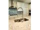 Close up of kitchen sink with stainless steel faucet and granite countertop at 4734 Cleome Dr, Plainfield, IN 46168