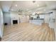 Spacious open-concept living space featuring a fireplace, kitchen island, and wood flooring at 4734 Cleome Dr, Plainfield, IN 46168
