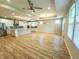 Bright living space with open kitchen featuring stainless steel appliances and wood flooring throughout at 4734 Cleome Dr, Plainfield, IN 46168