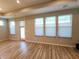 Bright living room features wood floors, natural light from multiple windows and a glass door at 4734 Cleome Dr, Plainfield, IN 46168