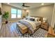 Spacious main bedroom boasting a ceiling fan, a large window, and stylish wood furniture at 4734 Cleome Dr, Plainfield, IN 46168