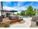 A backyard patio with outdoor furniture, a swimming pool, and manicured landscaping creates a serene outdoor space at 48 E Wisteria Way, Westfield, IN 46074