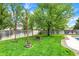 Spacious backyard with lush green lawn, mature trees, fire pit, and privacy fence at 48 E Wisteria Way, Westfield, IN 46074