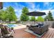Inviting backyard pool area with comfortable patio furniture and lush landscaping, perfect for outdoor living at 48 E Wisteria Way, Westfield, IN 46074
