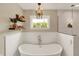 Elegant bathroom with a luxurious soaking tub, a shower with a glass door, and tasteful decorations at 48 E Wisteria Way, Westfield, IN 46074