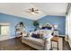 Bedroom features a blue accent wall, a large window and decor shelving at 48 E Wisteria Way, Westfield, IN 46074
