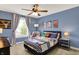 Stylish bedroom with a sports theme, blue walls, and a cozy bed with plush pillows at 48 E Wisteria Way, Westfield, IN 46074
