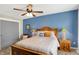 Bright bedroom with a wooden bed frame, large windows, and a stylish decor with blue accents at 48 E Wisteria Way, Westfield, IN 46074