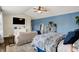 Spacious bedroom with blue accent wall, a ceiling fan and a TV on the wall at 48 E Wisteria Way, Westfield, IN 46074
