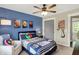 A colorful bedroom with sports-themed art, cozy armchair, and a playful, inviting ambiance at 48 E Wisteria Way, Westfield, IN 46074