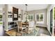 Dining area with wood-look floors, modern lighting, and lots of natural light at 48 E Wisteria Way, Westfield, IN 46074