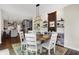 Open concept dining area with wood-look floors, modern lighting, and views of the kitchen at 48 E Wisteria Way, Westfield, IN 46074