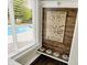 Charming built-in dog nook with feeding station and decorative 'A Dog's Life' sign, plus view to pool through bright window at 48 E Wisteria Way, Westfield, IN 46074