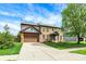 Traditional brick home with a well-kept lawn, two-car garage, and inviting curb appeal at 48 E Wisteria Way, Westfield, IN 46074