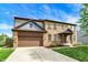 Attractive brick home with two-car garage, covered front porch, and neat landscaping at 48 E Wisteria Way, Westfield, IN 46074
