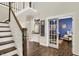 Elegant foyer with hardwood floors, a staircase, and a view into the blue office at 48 E Wisteria Way, Westfield, IN 46074