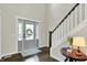 Bright foyer features hardwood floors, a staircase, and a stylish front door with sidelights at 48 E Wisteria Way, Westfield, IN 46074
