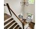 Bright foyer featuring wood stairs, a chandelier, and a gray front door at 48 E Wisteria Way, Westfield, IN 46074