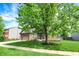Charming two-story brick home boasts a well-manicured lawn and mature tree at 48 E Wisteria Way, Westfield, IN 46074