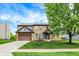 Inviting two-story brick home with a lush lawn, beautiful landscaping, and a two-car garage at 48 E Wisteria Way, Westfield, IN 46074