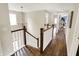 Hallway with wood floors and staircase, features view to room with blue accent wall at 48 E Wisteria Way, Westfield, IN 46074