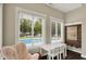 Charming office space with views of the pool, offering a cozy chair and functional table at 48 E Wisteria Way, Westfield, IN 46074