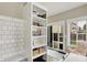 Bright dining space with white shelving unit, view of backyard and doggie door to exterior at 48 E Wisteria Way, Westfield, IN 46074