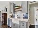 Charming kitchen with custom tile backsplash, undermount sink, stainless appliances, and open shelving at 48 E Wisteria Way, Westfield, IN 46074