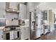 Kitchen with stainless steel appliances, grey cabinets, stylish backsplash and modern finishes at 48 E Wisteria Way, Westfield, IN 46074