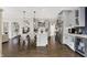Open kitchen with stainless steel appliances, light grey cabinets, and center island with dining space at 48 E Wisteria Way, Westfield, IN 46074