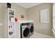 Efficient laundry room with modern washer and dryer, storage, and convenient countertop space at 48 E Wisteria Way, Westfield, IN 46074
