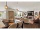 Open-concept living room with fireplace, large windows, and dining area with seating for six at 48 E Wisteria Way, Westfield, IN 46074