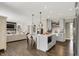 Open kitchen and living room with hardwood floors, kitchen island and casual seating at 48 E Wisteria Way, Westfield, IN 46074