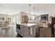 Open concept floor plan with modern kitchen island and large living area with a fireplace at 48 E Wisteria Way, Westfield, IN 46074