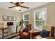 Comfortable home office space with two leather chairs, a desk, and bright natural lighting at 48 E Wisteria Way, Westfield, IN 46074