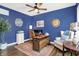Stylish home office with blue walls, modern desk, and comfortable seating area at 48 E Wisteria Way, Westfield, IN 46074