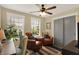 Bright and comfortable office space with a desk, armchairs, and large windows that offer a pleasant view at 48 E Wisteria Way, Westfield, IN 46074