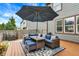 Outdoor patio with wicker furniture set, umbrella, and blue cushions, perfect for relaxing at 48 E Wisteria Way, Westfield, IN 46074