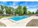 Inviting in-ground pool with a diving board, surrounded by lush landscaping and a secure fence at 48 E Wisteria Way, Westfield, IN 46074